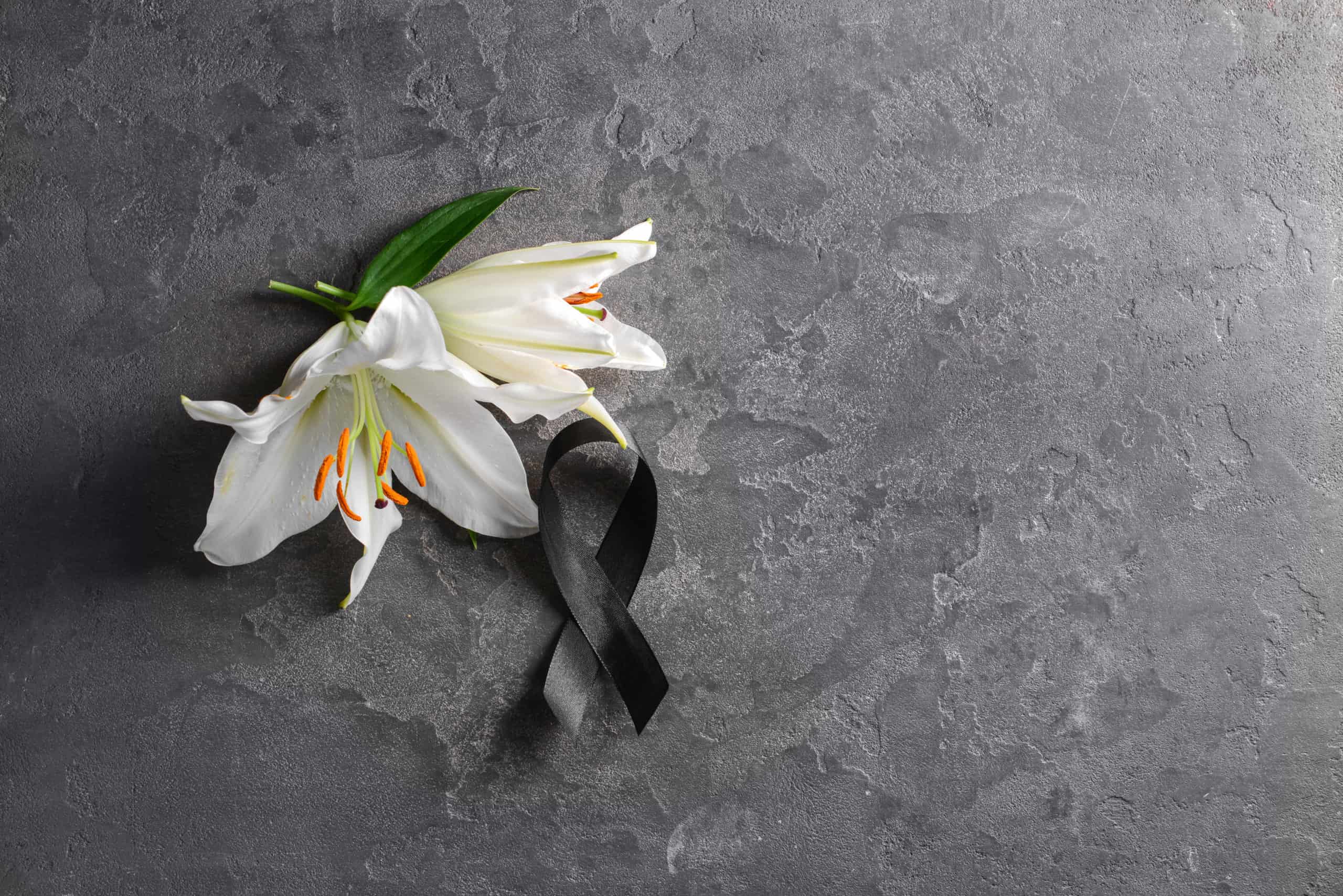 Kwiaty i wstążka symbolizująca żałobę